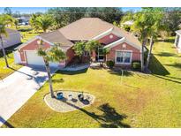 Aerial view of a charming ranch-style house with a well-manicured lawn at 183 Castile Ct, Punta Gorda, FL 33983