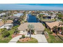 Aerial view of waterfront home with landscaped yard and community at 2748 Saint Thomas Dr, Punta Gorda, FL 33950