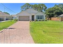 One-story home with a brick driveway and green lawn at 3924 Candia Ave, North Port, FL 34286