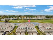 Stunning aerial view of townhomes overlooking a golf course and pond in a beautiful community at 43306 Water Bird Way # 6622, Punta Gorda, FL 33982