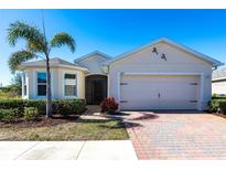 Single-story home with a two-car garage and landscaped yard at 5277 Shell Mound Cir, Punta Gorda, FL 33982