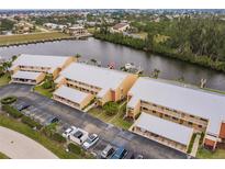 Aerial view of waterfront condo community with parking and private docks at 1348 Rock Dove Ct # C204, Punta Gorda, FL 33950