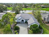 Luxury home with tile roof, driveway, and lush landscaping, situated on a golf course at 2209 Calusa Lakes Blvd, Nokomis, FL 34275