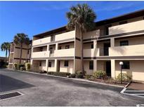 Condo building with palm trees and parking at 2395 Harbor Blvd # 324B, Port Charlotte, FL 33952