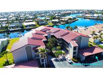 Aerial view of condo community, showing building, pool, and boat docks at 2601 W Marion Ave # 45C, Punta Gorda, FL 33950