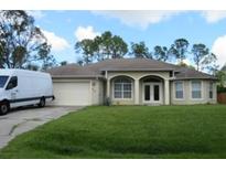 One-story house with attached garage and manicured lawn at 4320 Amanda Ave, North Port, FL 34286