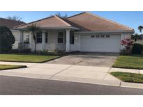 One-story home with tile roof, attached garage, and manicured lawn at 6379 Grand Cypress Blvd, North Port, FL 34287