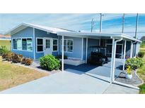 Cute Florida home with carport and golf cart at 739 Tangerine Woods Blvd, Englewood, FL 34223