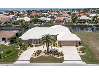 Aerial view of waterfront home with large lot and circular driveway at 920 Via Tripoli, Punta Gorda, FL 33950