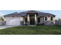 Modern house with gray roof and stone accents at 12 Ebb Cir, Placida, FL 33946