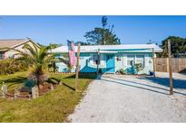 Charming beach cottage with a blue facade and gravel driveway at 159 Date St, Punta Gorda, FL 33980