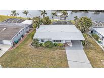 Aerial view of single-story home with water access at 407 Dunn Ne Dr, Port Charlotte, FL 33952