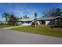 Ranch-style home with carport and mature landscaping at 422 Omen St, Punta Gorda, FL 33982