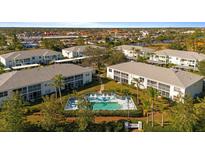 Aerial view of community with pool and multiple buildings at 5725 Greenwood Ave # 7203, North Port, FL 34287