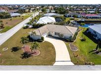 Aerial view of a single-Gathering home with a large lot and canal access at 900 Genoa Ct, Punta Gorda, FL 33950