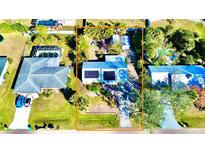 Aerial view of a house with solar panels and a spacious backyard at 22398 Walton Ave, Port Charlotte, FL 33952
