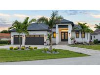 Stunning curb appeal! This home features a modern design, 2-car garage, and lush landscaping at 3800 Carupano Ct, Punta Gorda, FL 33950