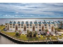 Aerial view of waterfront townhouses with parking and boat slips at 4410 Warren Ave # 504, Port Charlotte, FL 33953
