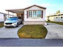 Single-wide manufactured home with carport and small yard at 6501 Center Ln, North Port, FL 34287