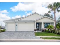 Two-story home with a three-car garage and attractive landscaping at 12717 Morning Mist Pl, Venice, FL 34293