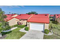 Charming home with vibrant red roof, two car garage and well maintained landscaping at 1890 Deborah Dr # 6, Punta Gorda, FL 33950