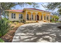 Beautiful one-story home with a circular driveway and lush landscaping at 21370 Harborside Blvd, Port Charlotte, FL 33952