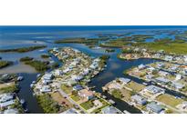 Aerial view of waterfront home with private dock and boat lift at 24248 Treasure Island Blvd, Punta Gorda, FL 33955