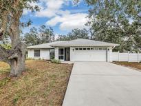 White house with gray roof, driveway, and landscaping at 2771 Siesta Dr, Venice, FL 34293