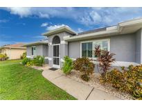 Gray house with landscaped yard and walkway at 3183 Sulstone Dr, Punta Gorda, FL 33983