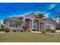 Beautiful home featuring well-maintained landscaping, white-framed windows, and a neutral color scheme at 336 Japura St, Punta Gorda, FL 33983