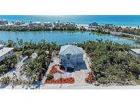 Beautiful coastal home features lush landscaping, water access and serene views of bay and ocean at 37 Bocilla Dr, Placida, FL 33946