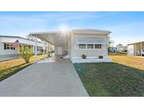 Charming single-story home featuring a long driveway and covered parking area at 6835 Anapa Ct, North Port, FL 34287