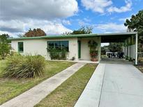 Charming ranch home with carport and landscaped yard at 761 Dalton Blvd, Port Charlotte, FL 33952