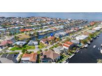 Waterfront home featuring canal access, lush landscaping, and a tranquil neighborhood setting at 2284 Palm Tree Dr, Punta Gorda, FL 33950