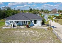 Charming single-story home with a well-manicured front yard and a cozy, inviting porch area at 3714 Gulfbreeze Ln, Punta Gorda, FL 33950