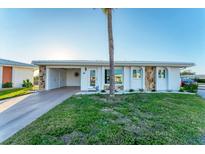 Charming single-story home with stone accents, a carport, and well-maintained landscaping at 92 Circlewood Dr # B3-1, Venice, FL 34293