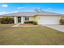 Charming single-story home featuring a two-car garage and well-maintained lawn and mature landscaping at 1364 Ultramarine Ln, Punta Gorda, FL 33983