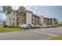 Exterior of building featuring balconies and parking at 1999 Kings Hwy # 21A, Punta Gorda, FL 33980