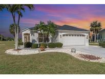 Charming single Gathering home featuring a barrel tile roof and a well manicured lawn with decorative rock at 10256 Shadow Run Ct, Punta Gorda, FL 33955