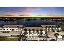 Beautiful aerial view of condos with lake view at sunset at 26300 Rampart Blvd # 404, Punta Gorda, FL 33983