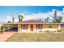 Inviting single-story home featuring a bright facade, covered carport, and simple landscaping at 6272 Morning Ave, North Port, FL 34287