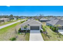 Well-maintained single-story home featuring a two-car garage and a beautifully landscaped front yard at 149 Hercules Dr, Rotonda West, FL 33947