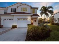 Charming townhome with a two-car garage, beautiful landscaping, and a cozy front porch at 1071 Jonah Dr, North Port, FL 34289