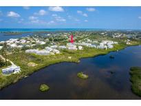 Aerial view of waterfront property, showcasing the building's location and surrounding landscape at 10309 Coral Landings Ct # 101, Placida, FL 33946