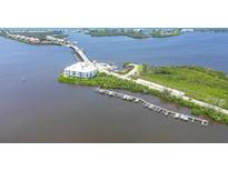 Aerial view of waterfront property with boat slips and a modern building at 1375 Beach Rd # 210, Englewood, FL 34223