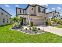 Two-story house with stone accents and landscaped yard at 7537 Pool Compass Loop, Wesley Chapel, FL 33545