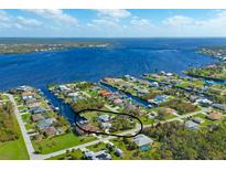 Aerial view showcasing home's waterfront location and neighborhood at 5105 Ackley Ter, Port Charlotte, FL 33981