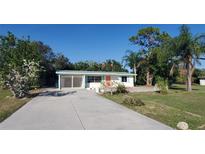 Ranch style home with a large yard and driveway at 1446 Fairless Rd, Englewood, FL 34223