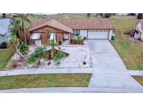 Single-story home with a two-car garage and landscaped yard at 6358 Granger Rd, Port Charlotte, FL 33981