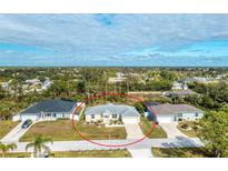 Aerial view of single-story house with attached garage and yard at 10430 Chablis Ave, Englewood, FL 34224